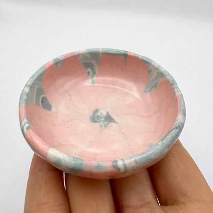 Handmade Sakura Nerikomi porcelain dipping bowl and jewelry holder with a pink and white marbled pattern, measuring 2 inches in diameter.
