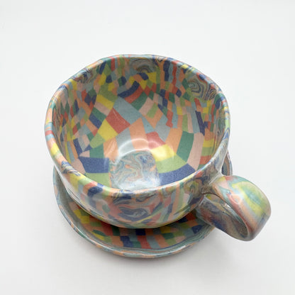 Handmade Rainbow Nerikomi porcelain mug and saucer set with vibrant multi-colored marbled patterns and a glossy clear glaze, 6-8 oz capacity.
