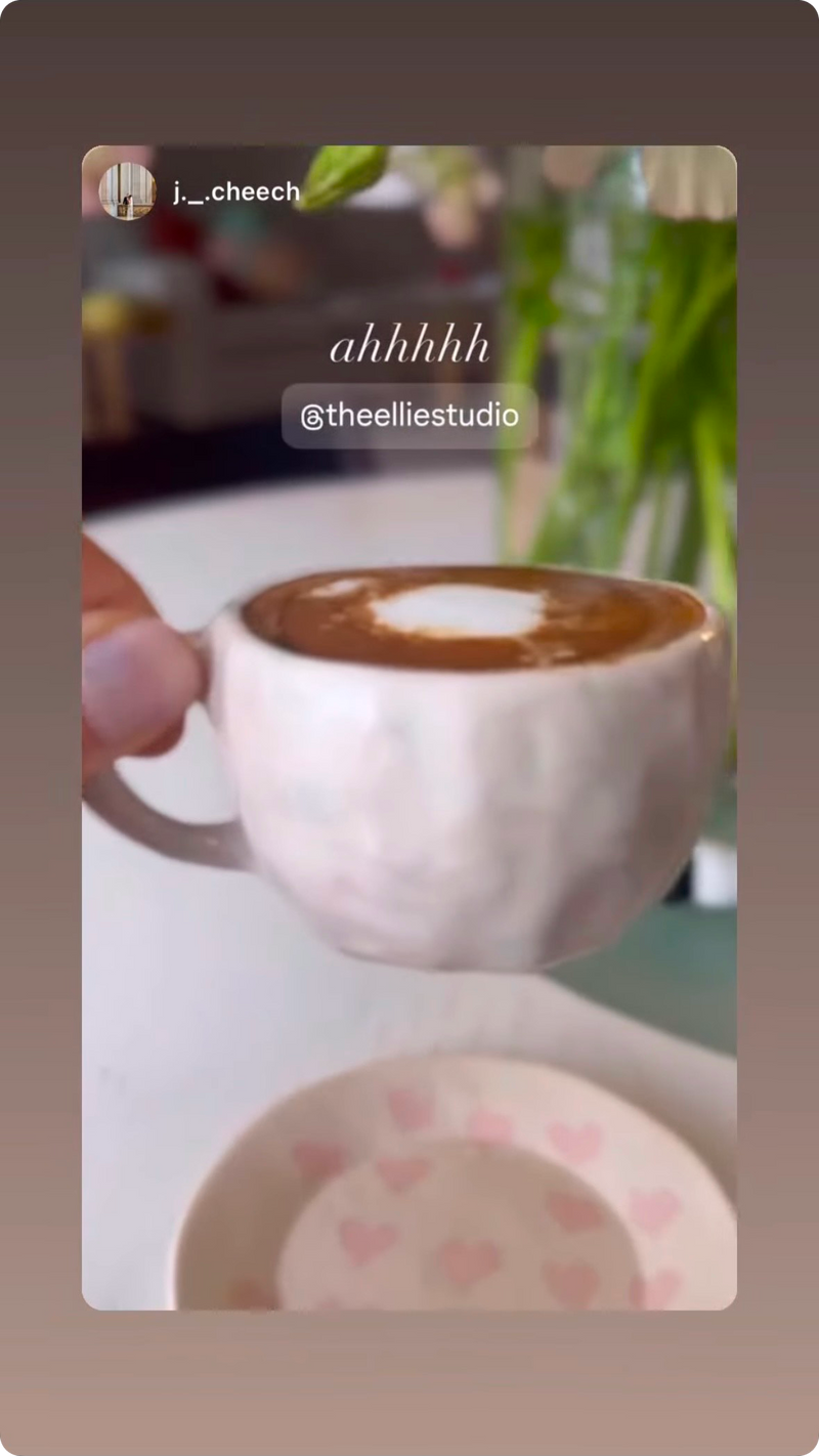 cute creamy white pastel pink espresoo mug with a pink heart patterned nerikomi saucer with green in the background, cute lifestyle chill afternoon tea