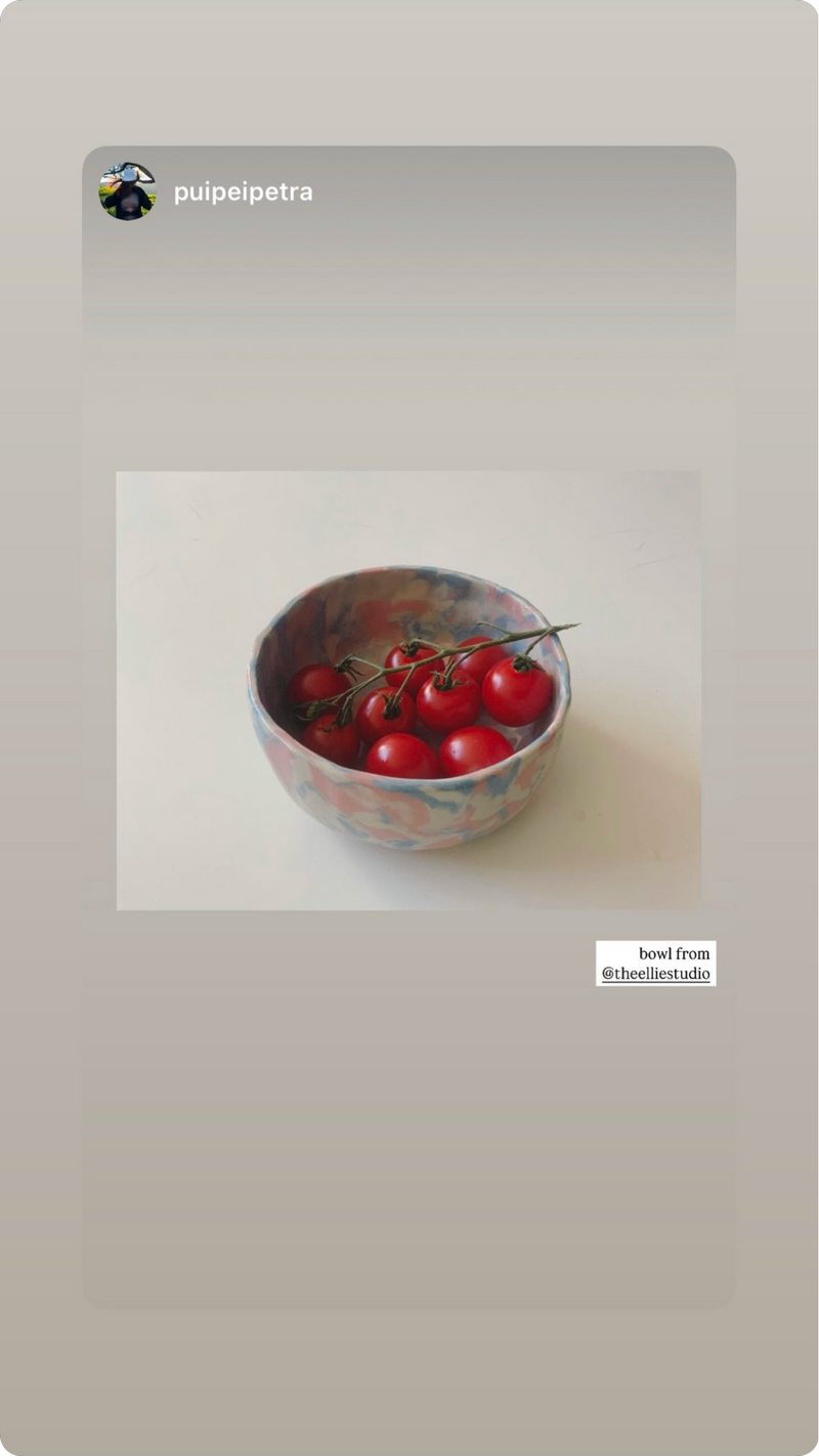 Creamy white pink and blue pastel bowl with tomato inside