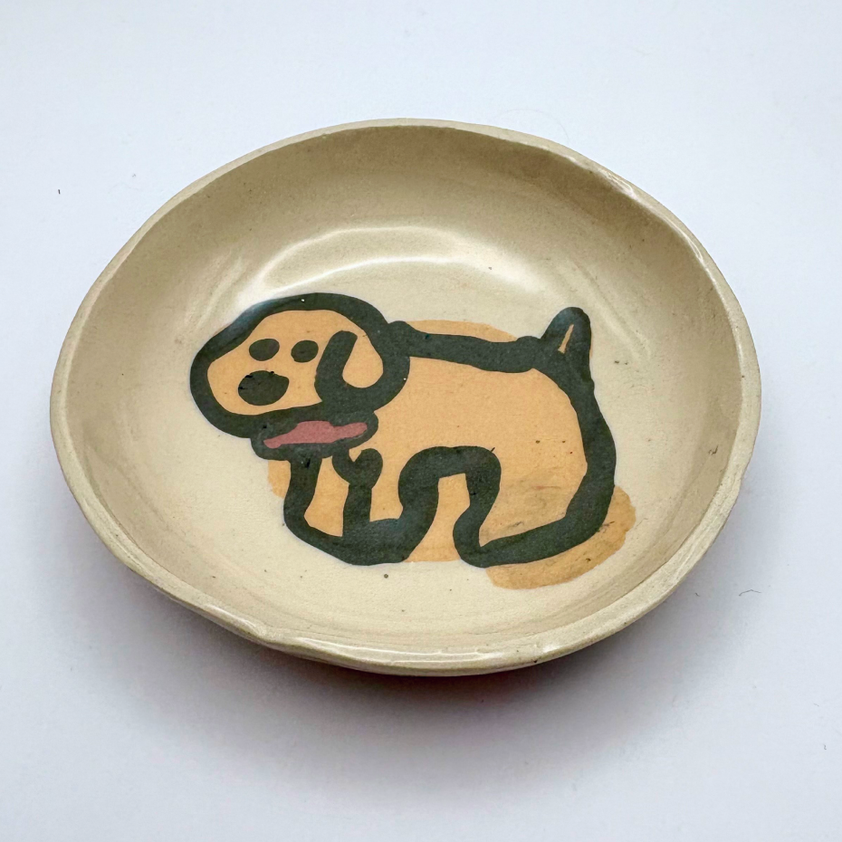 Handmade patterned ceramic plates created by students in a Nerikomi workshop. Cute yellow dog