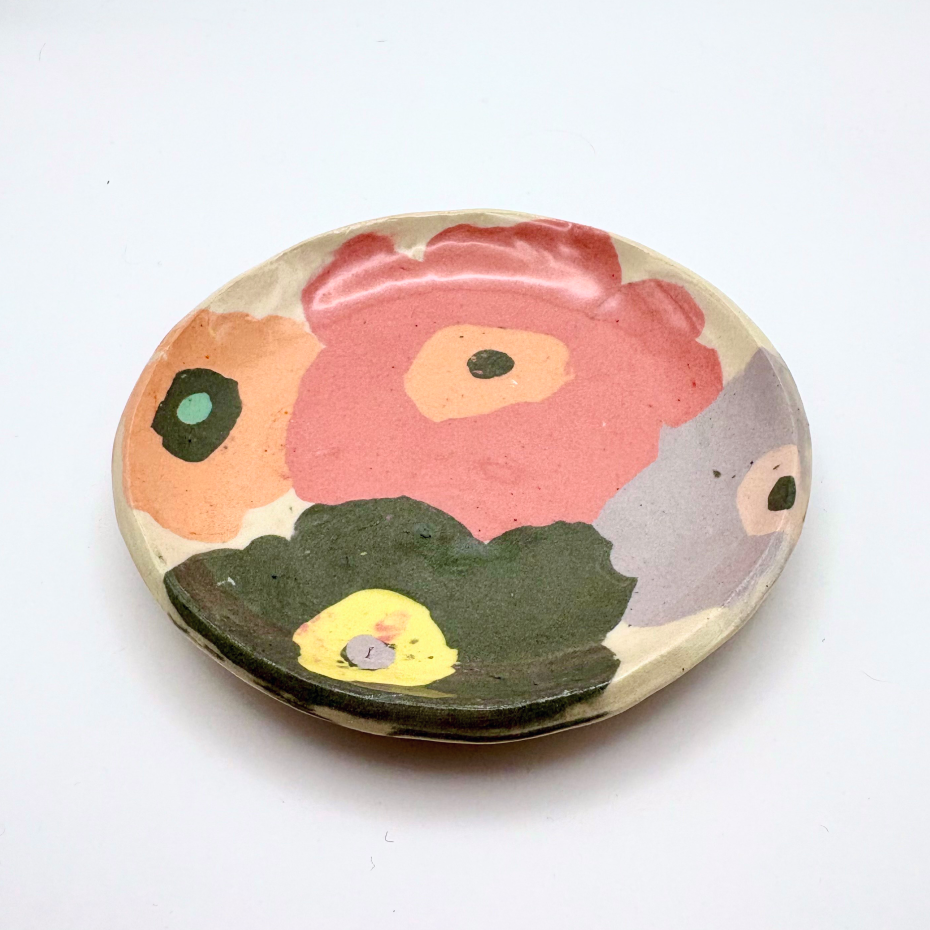 Handmade patterned ceramic plates created by students in a Nerikomi workshop. Artistic flowers