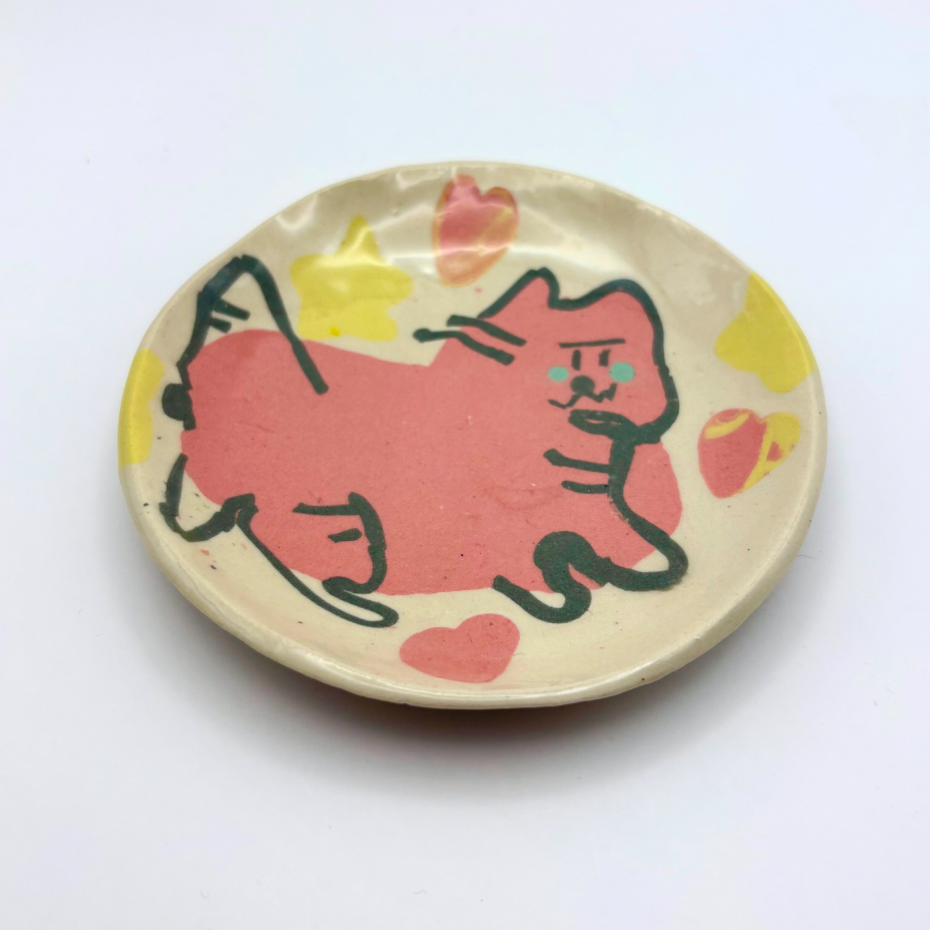 Handmade patterned ceramic plates created by students in a Nerikomi workshop, cute cat with heart and stars