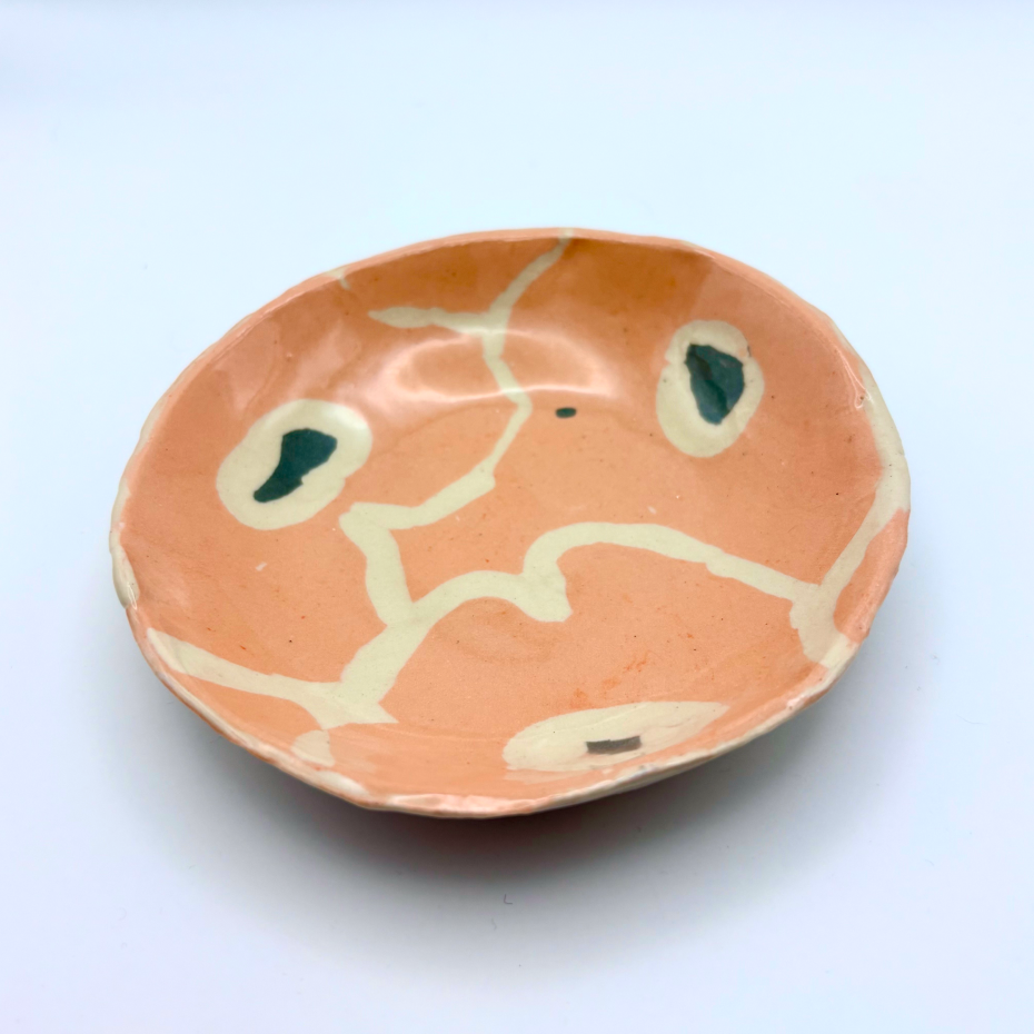 Handmade patterned ceramic plates created by students in a Nerikomi workshop. Artistic flowers