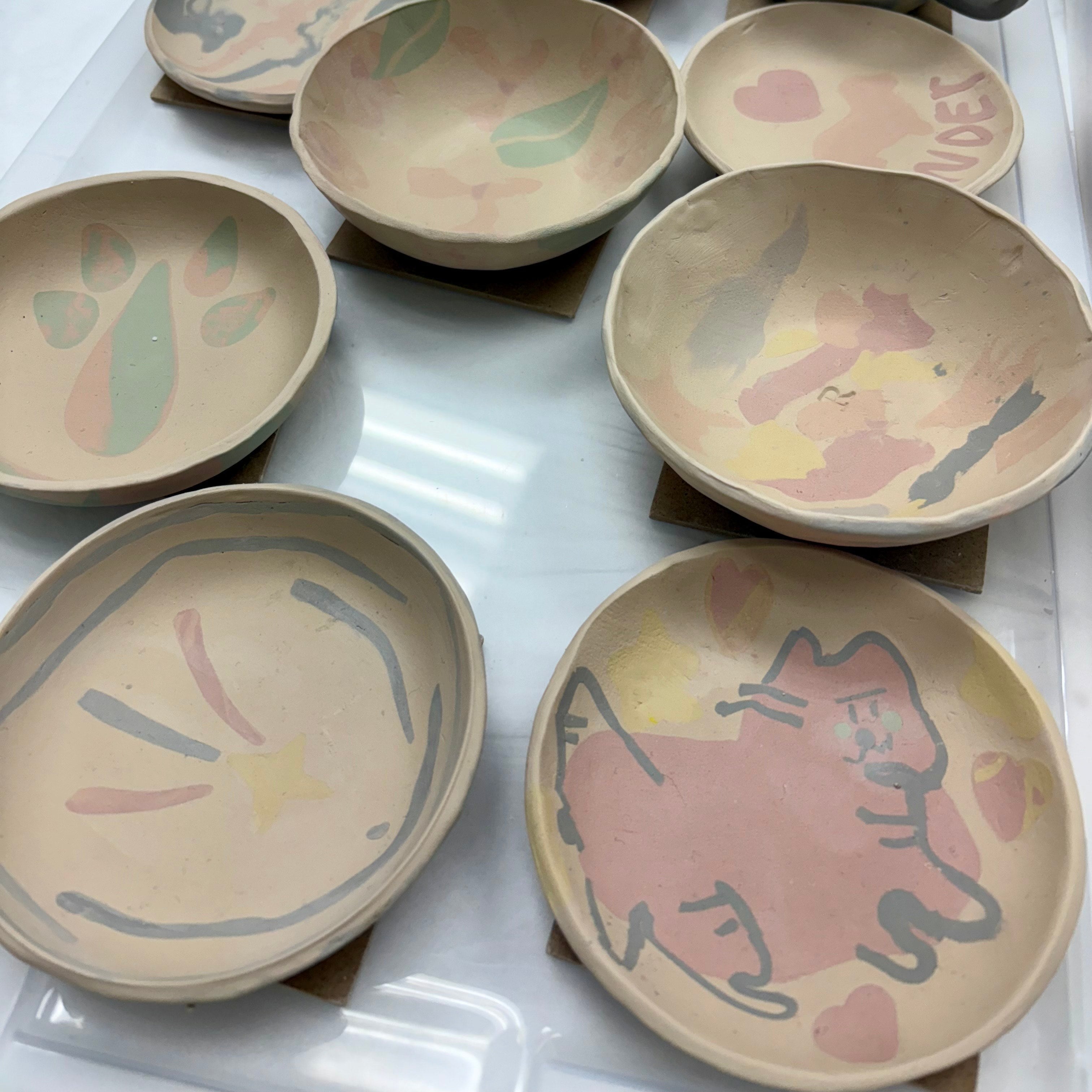 Set of nerikomi ceramic bowls with artistic designs on a white surface